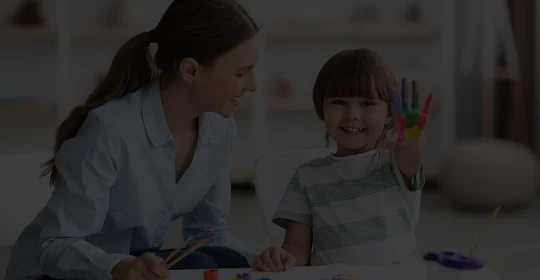 a woman and a child painting