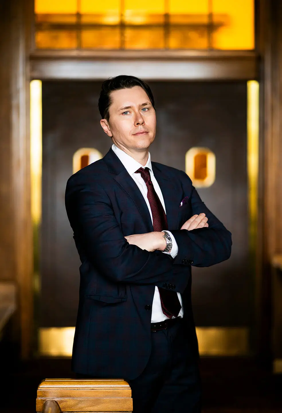 a man in a suit with his arms crossed