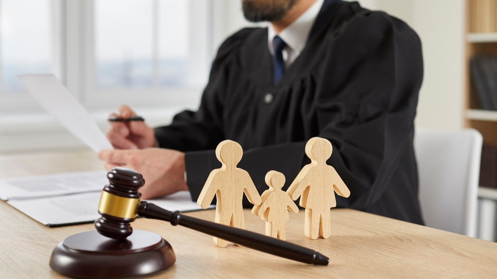 Gavel and little wooden figures of husband