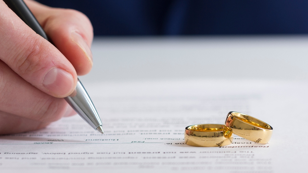 man is signing divorce document