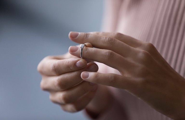 young woman takes off wedding ring