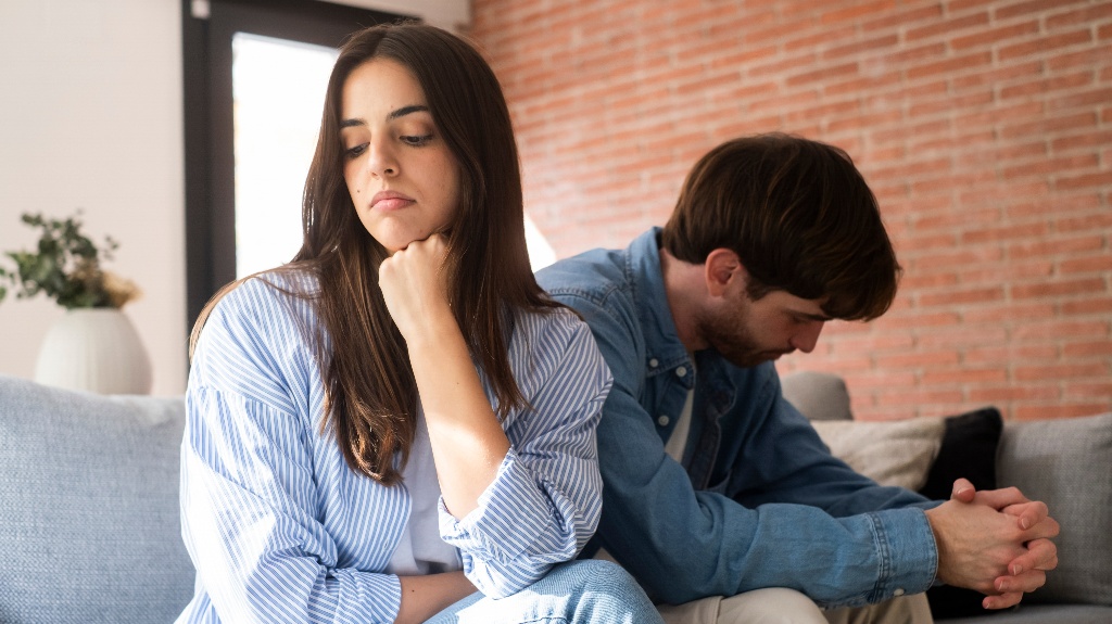 unhappy young couple sitting apart