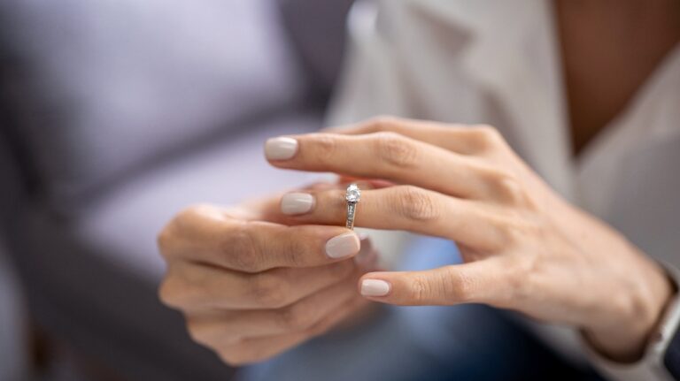 Young woman takes off wedding ring