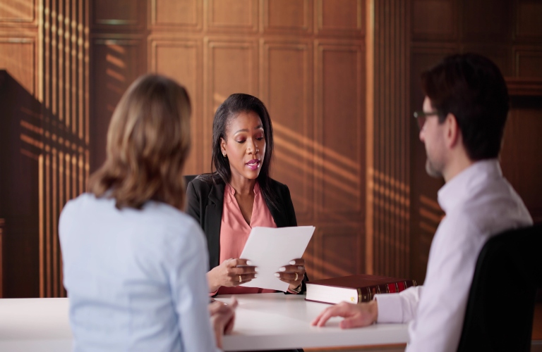 lawyer reviewing paperwork with couple